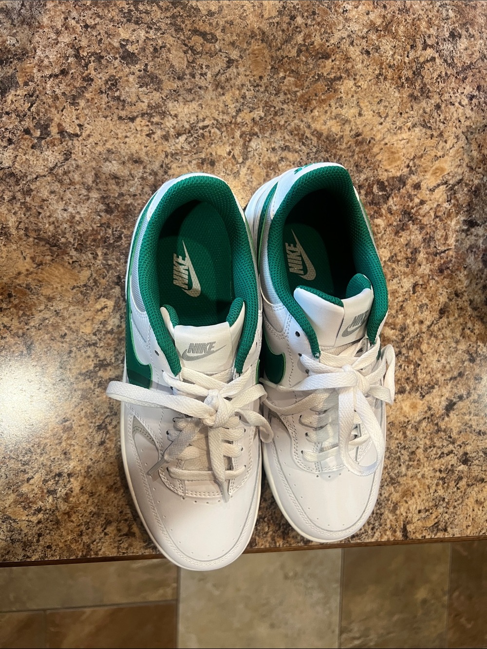 Women’s Nike shoes white and green.